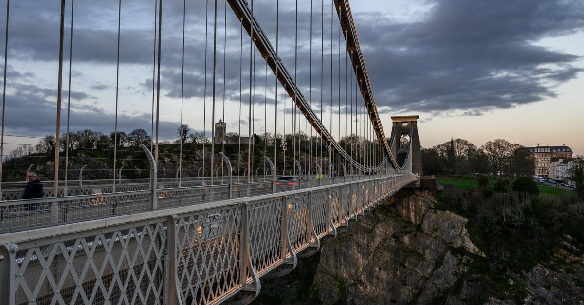 A picturesque view of the Clifton Suspension Bridge in Bristol during twilight, showcasing its architectural marvel.