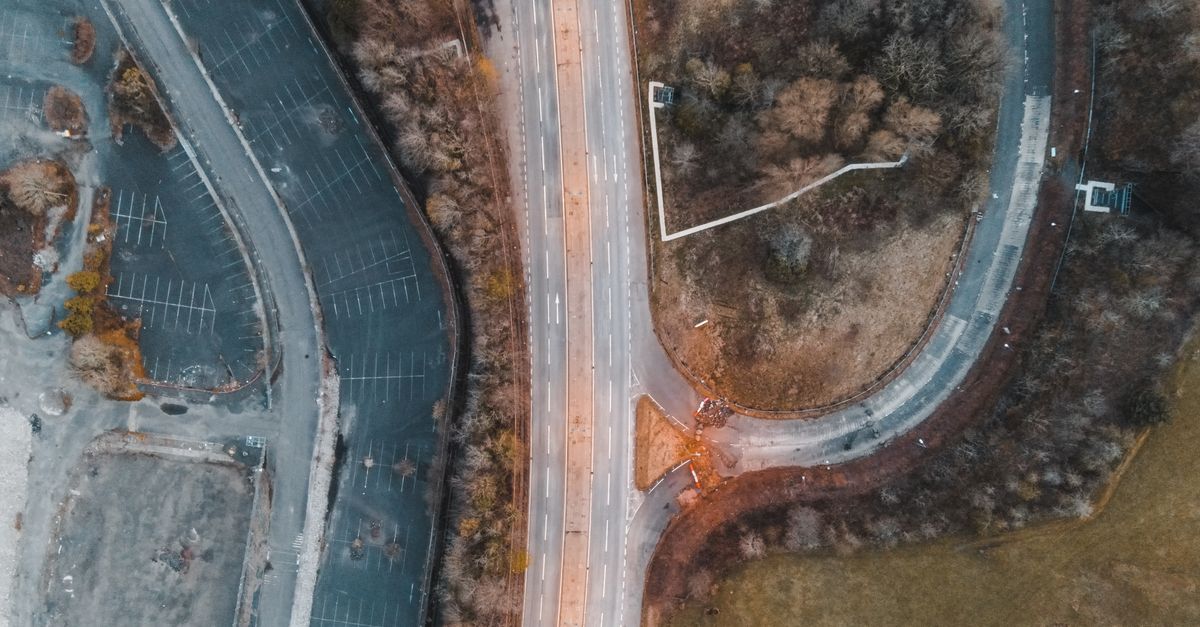 Aerial view of an empty road and roundabout at dusk