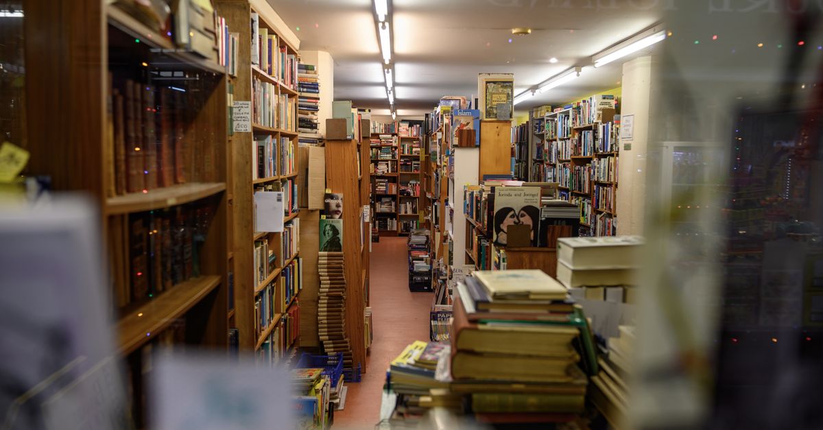 A warm and inviting bookstore filled with stacked bookshelves in Bristol, UK.